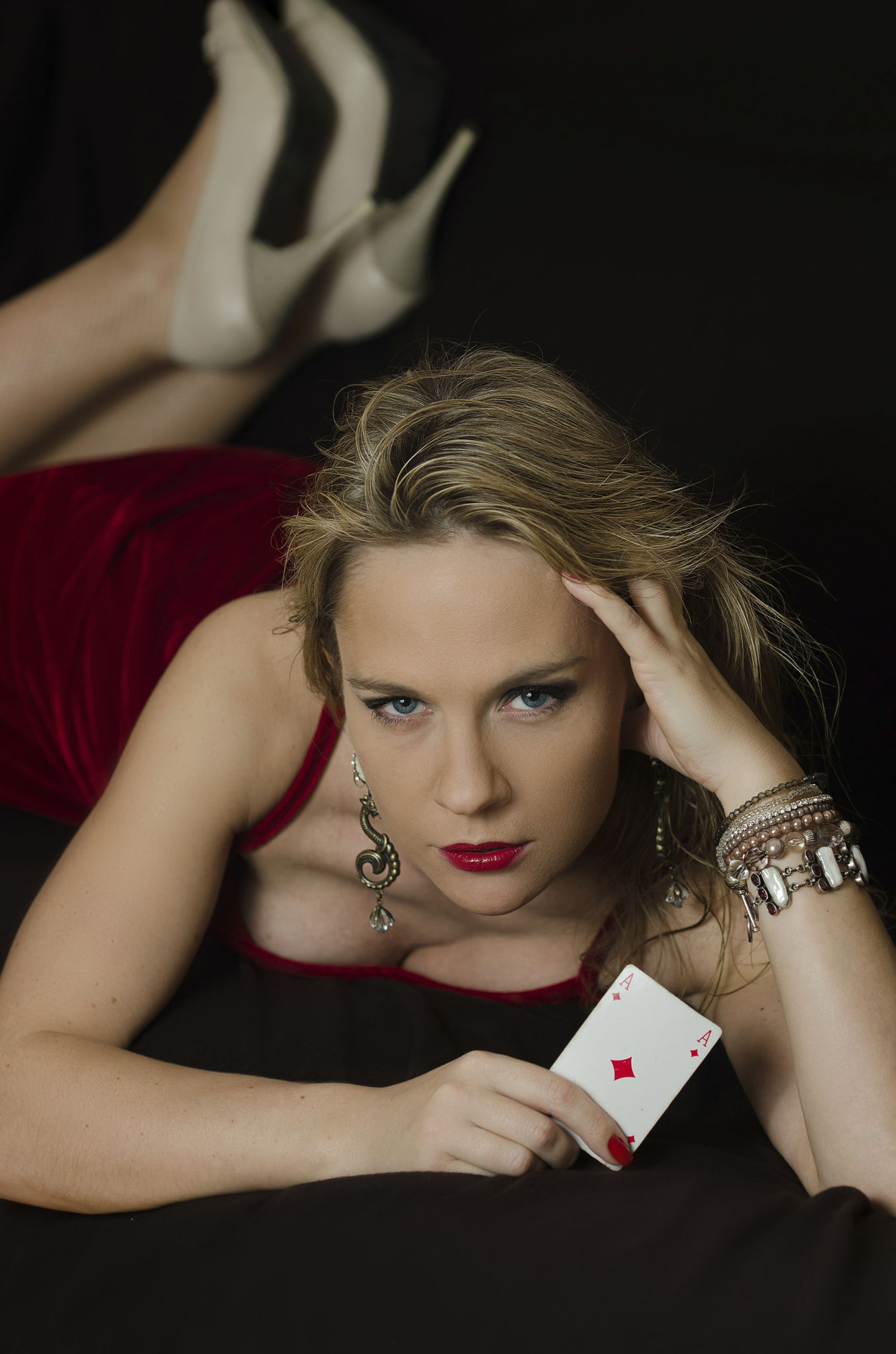 Woman in red with playing card Woman in red with playing card