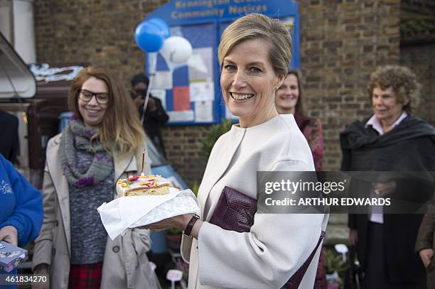 Britain's Sophie, Countess of Wessex, smiles after being presented with a slice of cake to celebrate her 50th birthday during a visit to Tomorrow's...