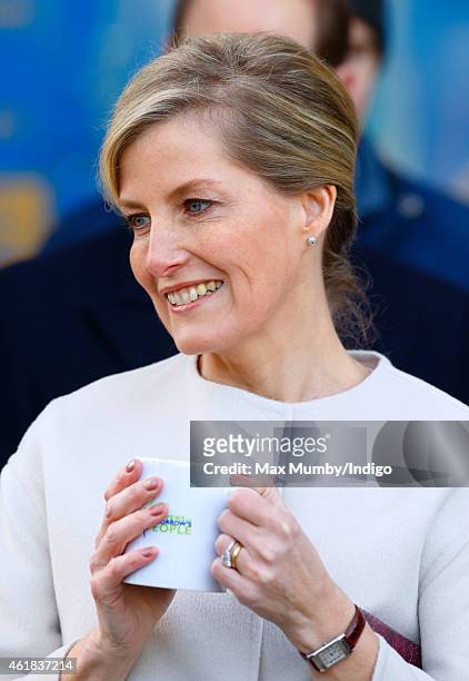 Sophie, Countess of Wessex drinks a cup of coffee as she and Prince Edward, Earl of Wessex visit the Tomorrow's People Social Enterprises at St...
