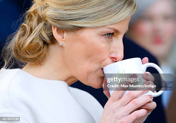 Sophie, Countess of Wessex drinks a cup of coffee as she and Prince Edward, Earl of Wessex visit the Tomorrow's People Social Enterprises at St...