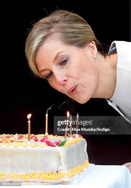 Sophie, Countess of Wessex blows out the candles on her birthday cake as she and Prince Edward, Earl of Wessex visit the Tomorrow's People Social...