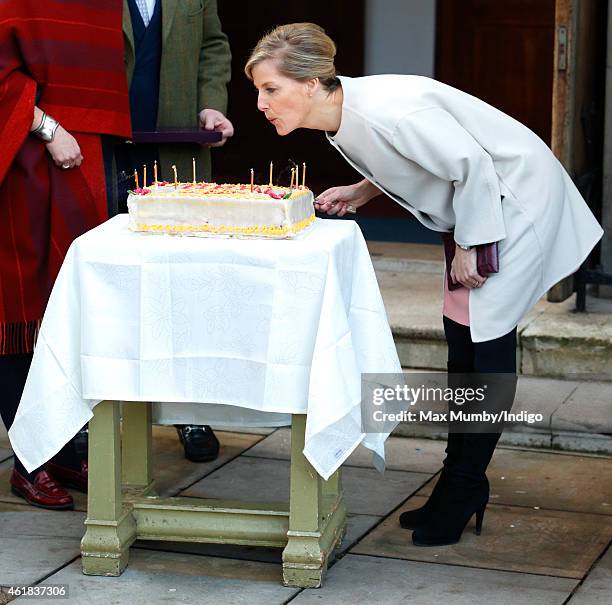 Sophie, Countess of Wessex blows out the candles on her birthday cake as she and Prince Edward, Earl of Wessex visit the Tomorrow's People Social...