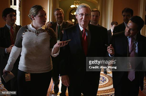 Flanked by members of the media, U.S. Senate Majority Leader Sen. Mitch McConnell walks back to his office after the Senate Republican weekly policy...