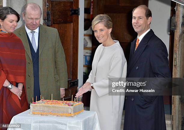 Sophie, Countess of Wessex, accompanied by Prince Edward, Earl of Wessex, prepares to cut her birthday cake during a visit to Tomorrow's People...