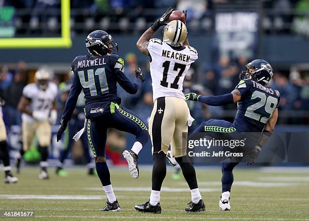 Cornerback Byron Maxwell and free safety Earl Thomas of the Seattle Seahawks are unable to make an interception as the ball is caught by wide...