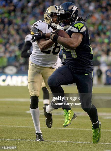 Running back Marshawn Lynch of the Seattle Seahawks scores a 31-yard touchdown run against the New Orleans Saints in the fourth quarter during the...