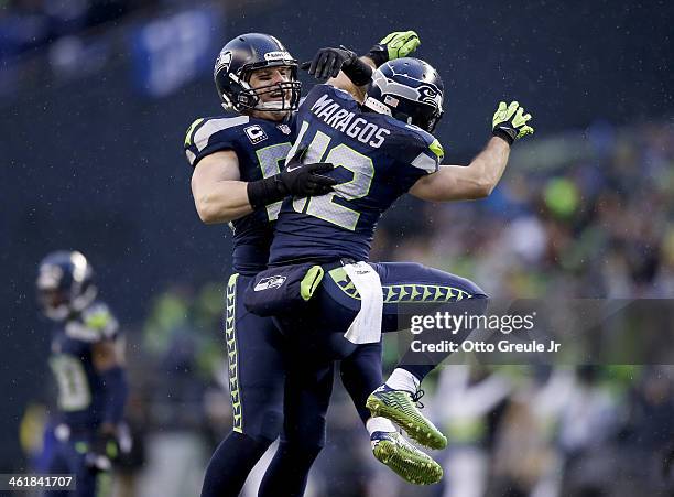 Heath Farwell and free safety Chris Maragos of the Seattle Seahawks celebrate in the fourth quarter while taking on the New Orleans Saints during the...