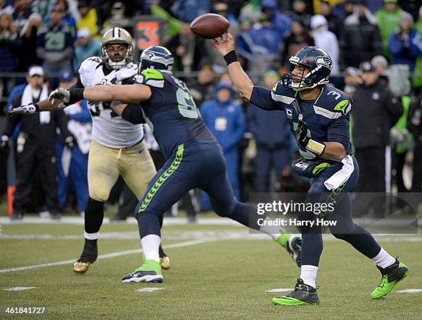 Quarterback Russell Wilson of the Seattle Seahawks throws the ball in the fourth quarter while taking on the New Orleans Saints during the NFC...