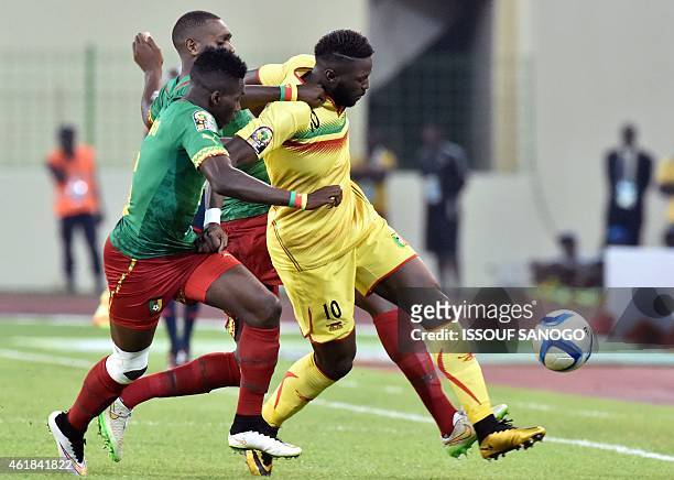 Mali's midfielder Bakary Sako challenges Cameroon's defender Ambroise Oyongo during the 2015 African Cup of Nations group D football match between...