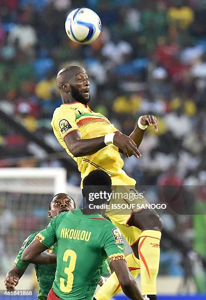 Mali's forward Mustapha Yatabare jumps to head the ball next to Cameroon's defender Nicolas Nkoulou during the 2015 African Cup of Nations group D...