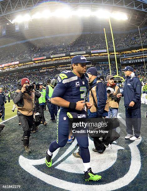 Quarterback Russell Wilson of the Seattle Seahawks runs off the field after the Seahawks 23-15 victory against the New Orleans Saints during the NFC...