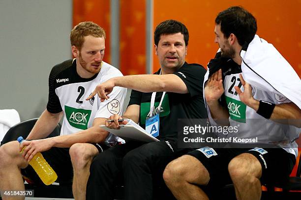 Alexander Haase, assistant coach of Germany speask to Stefan Kneer of Germany and Michael Mueller of Germany during the IHF Men's Handball World...