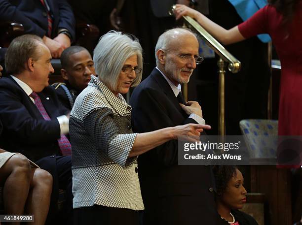 Alan Gross , recently freed after being held in Cuba since 2009, stands with wife Judy Gross before the start of the State of the Union speech in the...