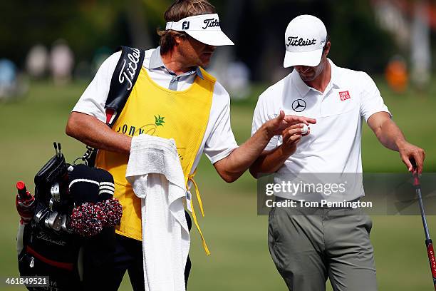 Big wave surfer Benji Weatherley caddies for Adam Scott of Australia during the third round of the Sony Open in Hawaii at Waialae Country Club on...