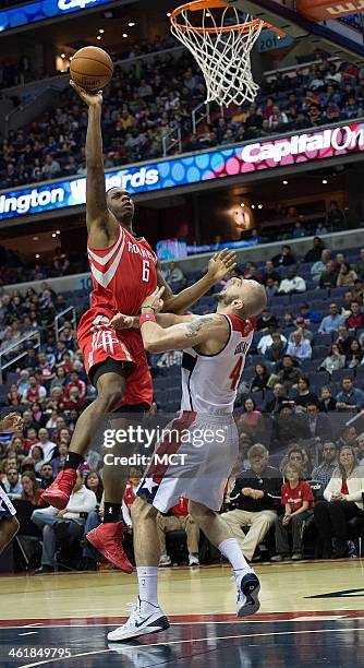 Houston Rockets power forward Terrence Jones charges into Washington Wizards center Marcin Gortat for a foul during the first half of their game...