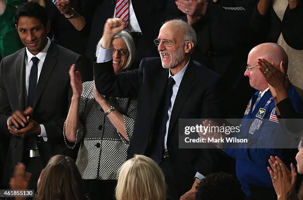 Alan Gross , recently freed after being held in Cuba since 2009, pumps his fist after being recognized by U.S. President Barack Obama during the...