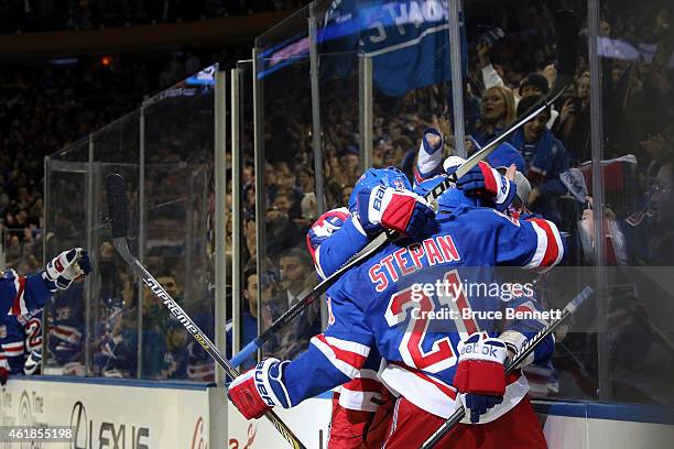 Carl Hagelin of the New York Rangers celebrates with his teammates after scoring the game winning goal against Craig Anderson of the Ottawa Senators...