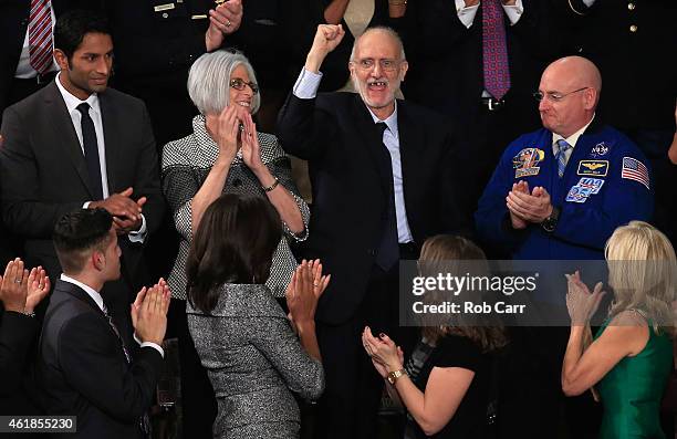 Alan Gross , recently freed after being held in Cuba since 2009, pumps his fist after being recognized by U.S. President Barack Obama during the...