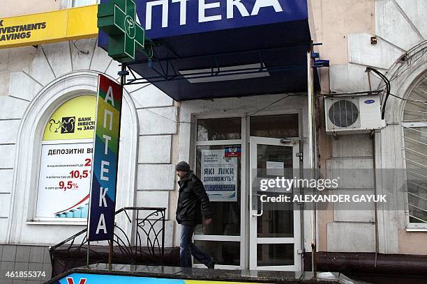 Man leaves a pharmacy where medicine is given for free in the eastern Ukrainian city of Donetsk, on January 20, 2015. Shortages are rampant,...