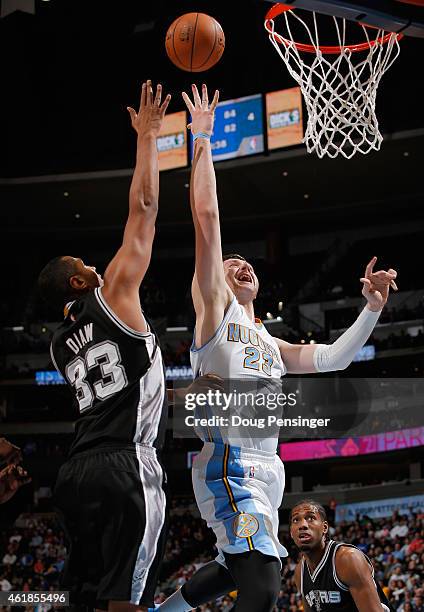 Jusuf Nurkic of the Denver Nuggets lays up a shot against the defense of Boris Diaw of the San Antonio Spurs at Pepsi Center on January 20, 2015 in...