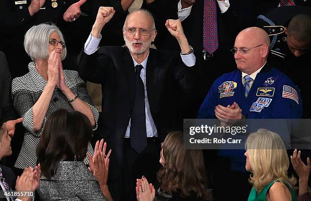 Alan Gross , recently freed after being held in Cuba since 2009, pumps his fist after being recognized by U.S. President Barack Obama during the...