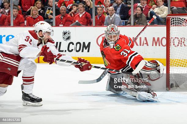 Lucas Lessio of the Arizona Coyotes scores on goalie Antti Raanta of the Chicago Blackhawks in the second period during the NHL game at the United...
