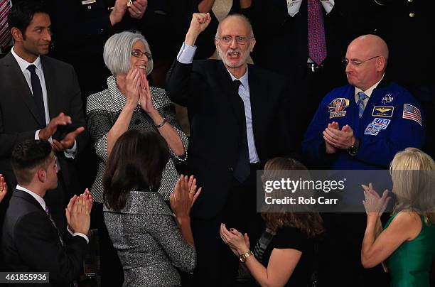 Alan Gross , recently freed after being held in Cuba since 2009, pumps his fist after being recognized by U.S. President Barack Obama during the...