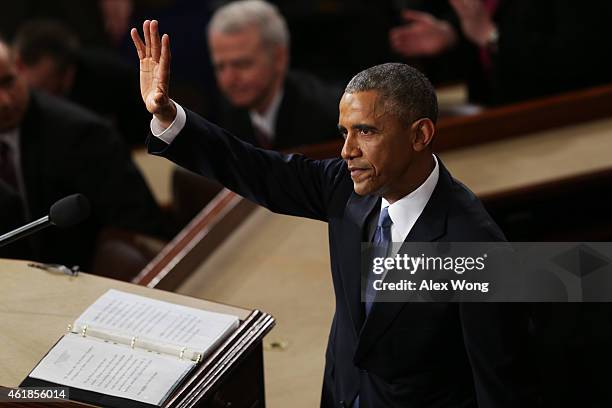 President Barack Obama waves at the conclusion of his State of the Union speech before members of Congress in the House chamber of the U.S. Capitol...