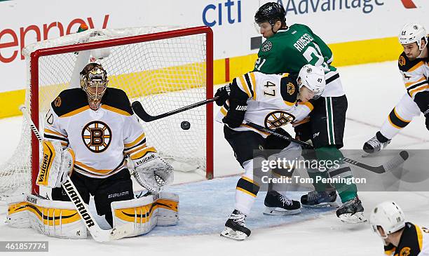 Antoine Roussel of the Dallas Stars tries to control the puck against Torey Krug of the Boston Bruins and Tuukka Rask of the Boston Bruins at...