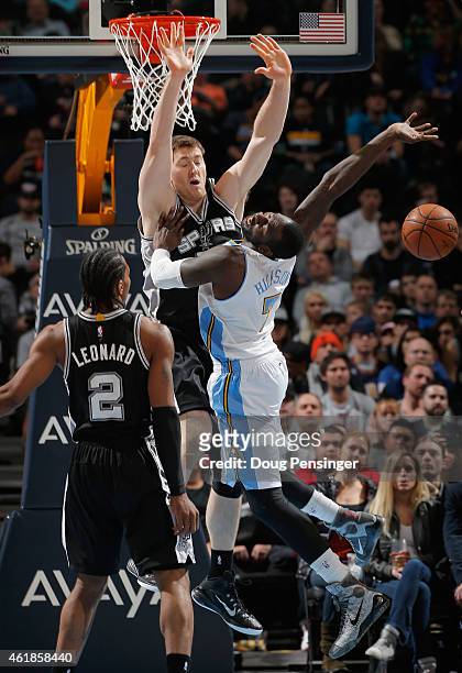 Hickson of the Denver Nuggets goes up for a shot and is fouled by Aron Baynes of the San Antonio Spurs as Kawhi Leonard of the San Antonio Spurs...