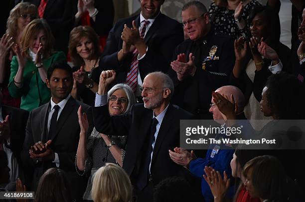 Former Cuban prisoner Alan Gross reacts as President Barack Obama references his ordeal as he delivers his State of the Union address before a joint...