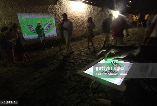 Artist Limpio creates a piece of 'digital graffitti' projected onto a wall in Salvador, which will host matches during the 2014 FIFA World Cup, on...