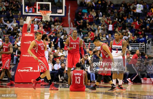 Francisco Garcia, Dwight Howard, and Jeremy Lin, celebrate after James Harden of the Houston Rockets hits a three pointer and was fouled by the...