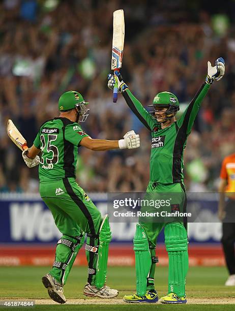 Peter Handscomb of the Melbourne Stars celebrates with team mate Scott Boland, after scoring the winning runs and a century during the Big Bash...