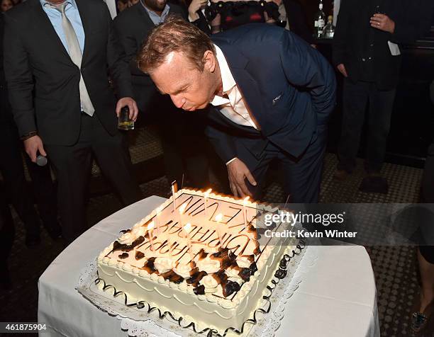 Actor Kevin Costner blows out the candles on his birthday cake at the after party for the premiere of Relativity Media's "Black Or White" at WP24 by...