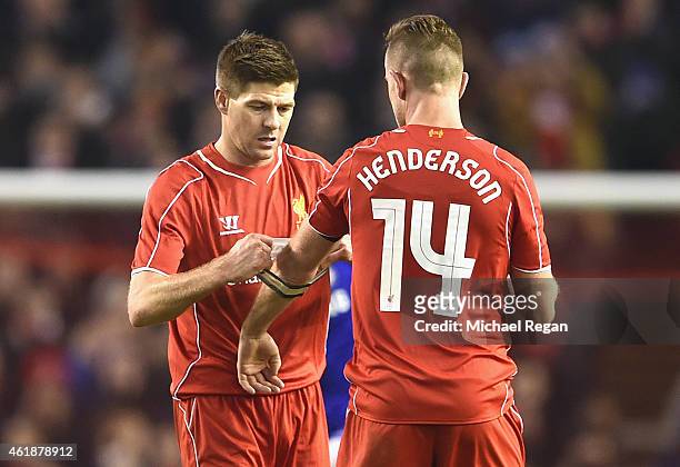 Steven Gerrard of Liverpool hands the Captain's arm band over to Jordan Henderson of Liverpool during the Capital One Cup Semi-Final first leg match...