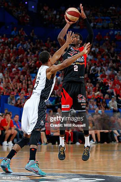 Stephen Dennis of United tries to block DeAndre Daniels of the Wildcats during the round 15 NBL match between the Perth Wildcats and Melbourne United...
