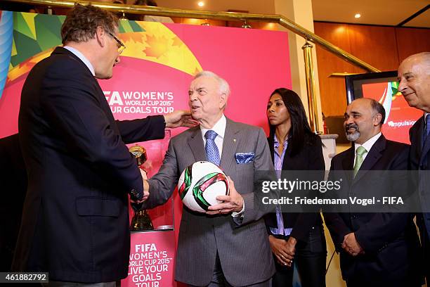 Secretary General, Jerome Valcke gives a ball to the CBF President Jose Maria Marin during the media briefing for forthcoming FIFA Women's World Cup...