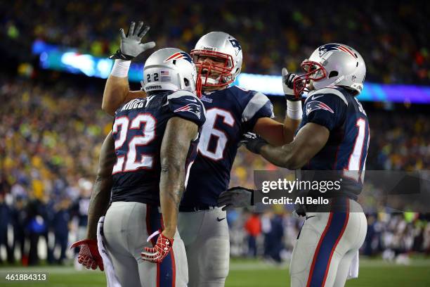 Stevan Ridley of the New England Patriots celebrates with teammates Matthew Slater and James Develin after scoring a touchdown in the fourth quarter...