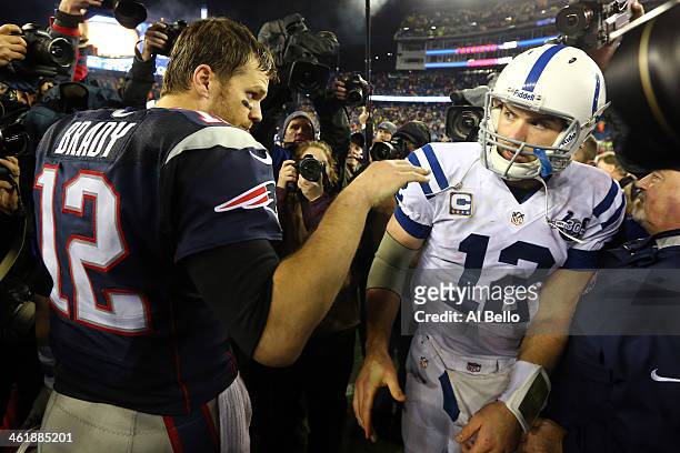 Tom Brady of the New England Patriots talks with Andrew Luck of the Indianapolis Colts after their AFC Divisional Playoff game at Gillette Stadium on...