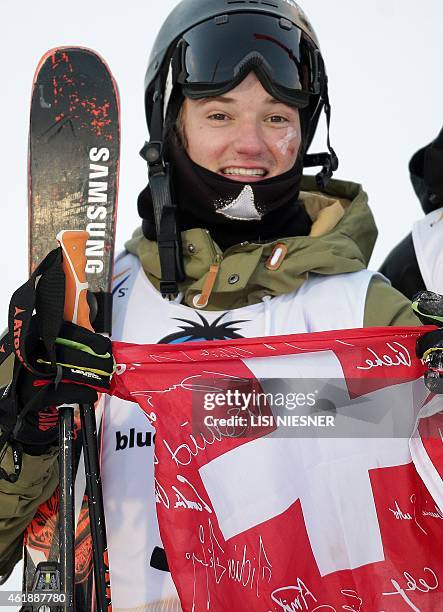 Winner Switzerland's Fabian Boesch poses with his national flag after the Men's Ski Slopestyle Finals of FIS Freestyle and Snowboarding World Ski...