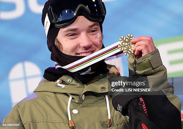 First placed Switzerland's Fabian Boesch celebrates on the podium after the Men's Ski Slopestyle Finals of FIS Freestyle and Snowboarding World Ski...