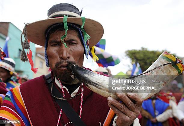 An Aymara native plays a horn during a parade held after a ritual ceremony for reelected Bolivian President Evo Morales, along the streets of the...