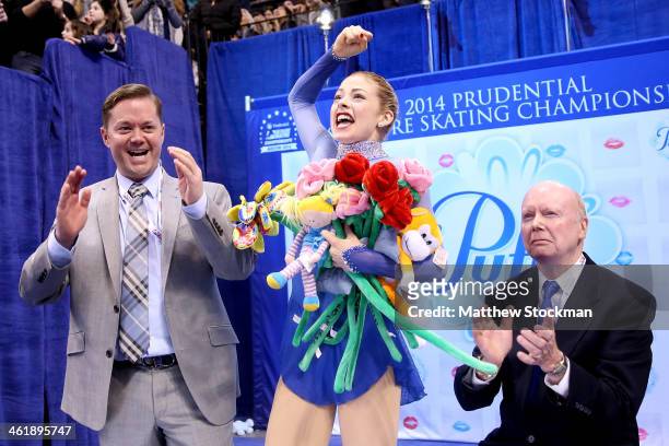 Gracie Gold, with her coaches Scott Brown and Frank Carroll, celebrates in the kiss and cry after skating in the ladies free skate during the...