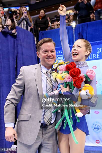 Gracie Gold, with her coach Scott Brown, celebrates in the kiss and cry after skating in the ladies free skate during the Prudential U.S. Figure...