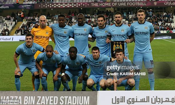 Manchester City's starting line-up pose for a group picture ahead of their friendly football match against Hamburg SV at the Hazza Bin Zayed stadium...