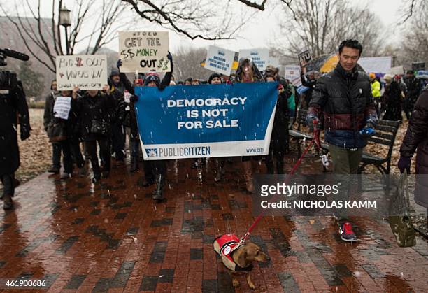 Demonstrators march in the snow through Lafayette Park, outside the White House, to the US Chamber of Commerce during a rally against the Supreme...