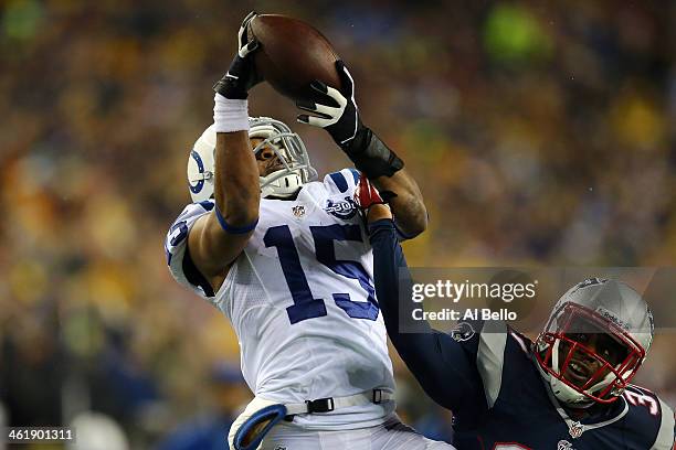 LaVon Brazill of the Indianapolis Colts catches a pass over Alfonzo Dennard of the New England Patriots during the AFC Divisional Playoff game at...