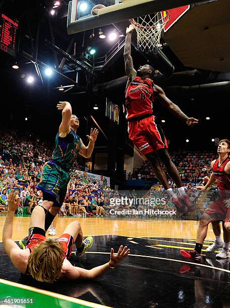 James Ennis of the Wildcats attempts to regather the ball with Brian Conklin of the Crocodiles during the round 13 NBL match between the Townsville...