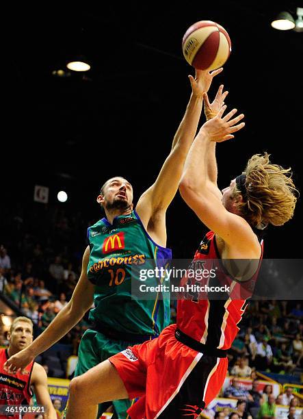 Jesse Wagstaff of the Wildcats attempts a jump shot over Russell Hinder of the Crocodiles during the round 13 NBL match between the Townsville...